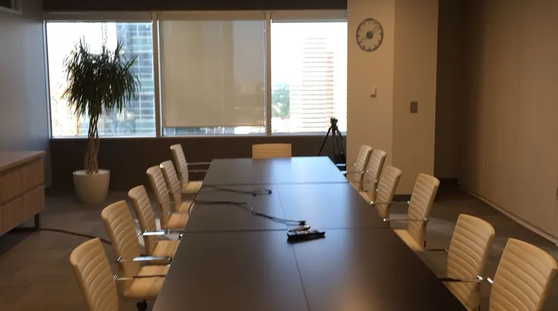 An empty meeting room with a long table